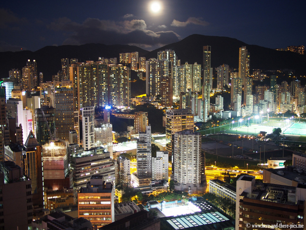 Full moon on buildings canopy in Hong Kong